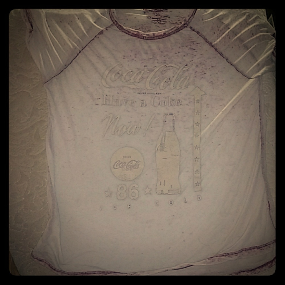 Coca-Cola shirt is see through it is red and white
